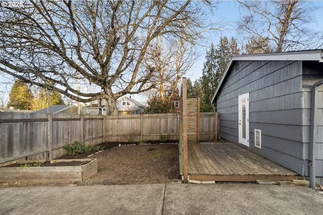 view of yard with a fenced backyard and a wooden deck