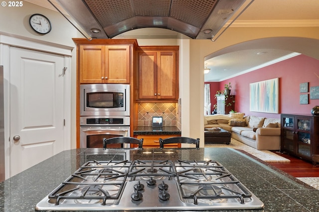 2036 NW Village Cir, Portland, OR 97229 - kitchen featuring stainless steel appliances, arched walkways, backsplash, crown molding, and open floor plan