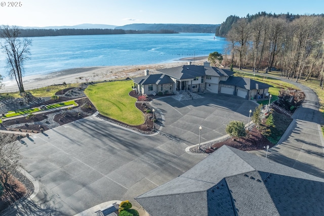 aerial view with a water view and a view of the beach