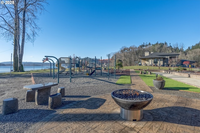 view of playground with a water view