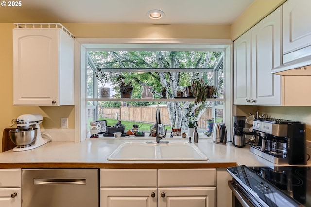 4730 SW 189th Pl, Beaverton, OR 97078 - kitchen with stainless steel dishwasher, light countertops, electric range oven, white cabinets, and a sink