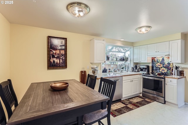 4730 SW 189th Pl, Beaverton, OR 97078 - kitchen with a sink, electric stove, dishwashing machine, under cabinet range hood, and white cabinetry
