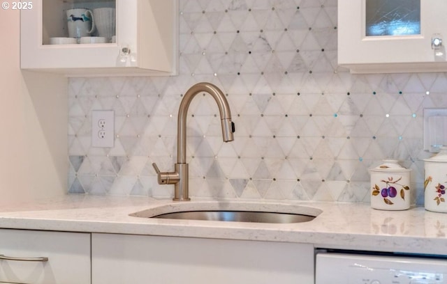 7522 SW Barnes Rd Unit H, Portland, OR 97225 - kitchen with a sink, dishwashing machine, white cabinets, glass insert cabinets, and decorative backsplash