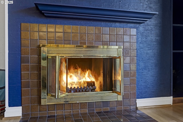 7522 SW Barnes Rd Unit H, Portland, OR 97225 - detailed view of a brick fireplace, baseboards, and wood finished floors