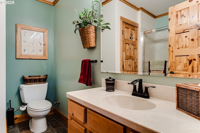 86561 R R Baker Rd, Springfield, OR 97478 - bathroom featuring vanity, toilet, a stall shower, baseboards, and ornamental molding