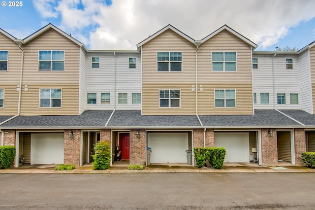 11220 SW Buffalo Pl, Tigard, OR 97223 - townhome / multi-family property with brick siding, roof with shingles, and an attached garage
