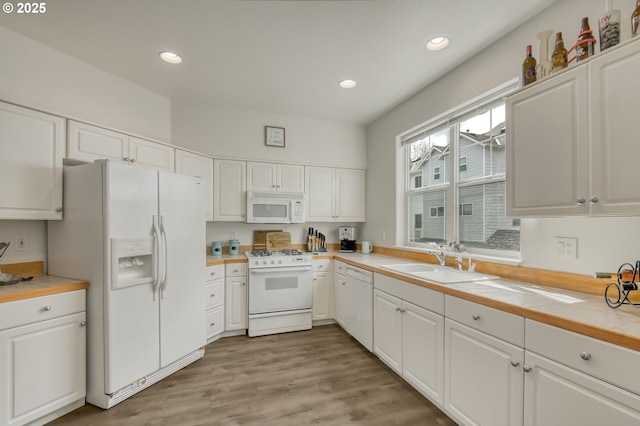 11220 SW Buffalo Pl, Tigard, OR 97223 - kitchen featuring white appliances, white cabinetry, recessed lighting, and light wood-type flooring