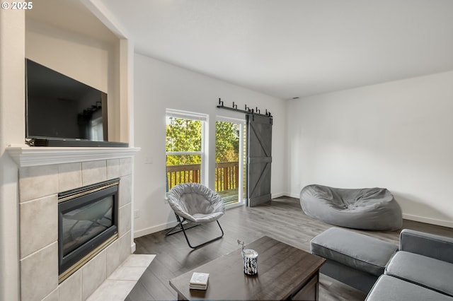 11220 SW Buffalo Pl, Tigard, OR 97223 - living area featuring a fireplace, wood finished floors, and a barn door