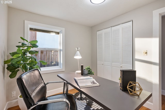 home office with hardwood / wood-style flooring