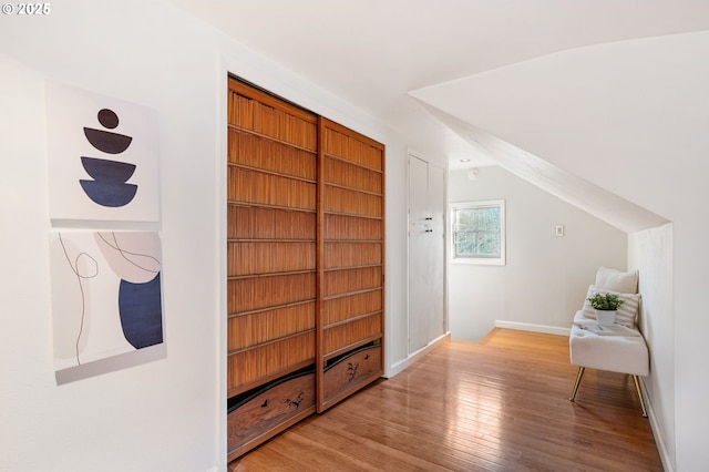 interior space featuring lofted ceiling and light hardwood / wood-style floors