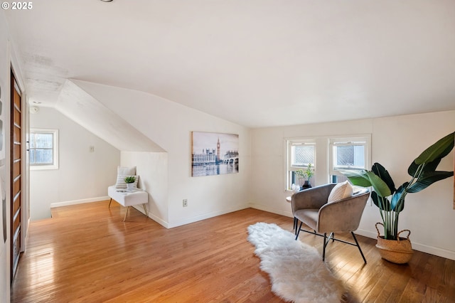 living area with light hardwood / wood-style flooring and vaulted ceiling