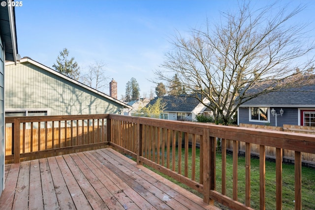 wooden terrace featuring a lawn