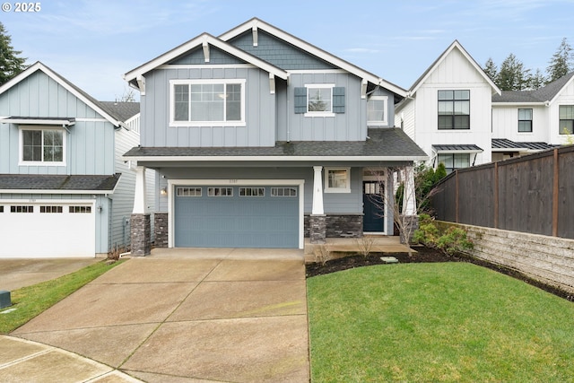 craftsman-style house featuring fence, a garage, board and batten siding, a front yard, and concrete driveway