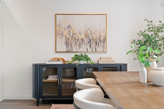 dining room featuring baseboards and wood finished floors