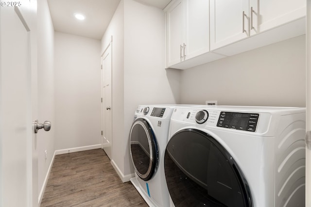 laundry area with baseboards, recessed lighting, cabinet space, washing machine and clothes dryer, and light wood-style flooring