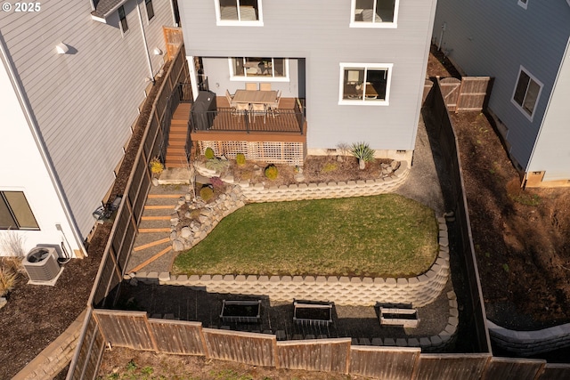 back of house with a fenced backyard, a lawn, cooling unit, and a deck