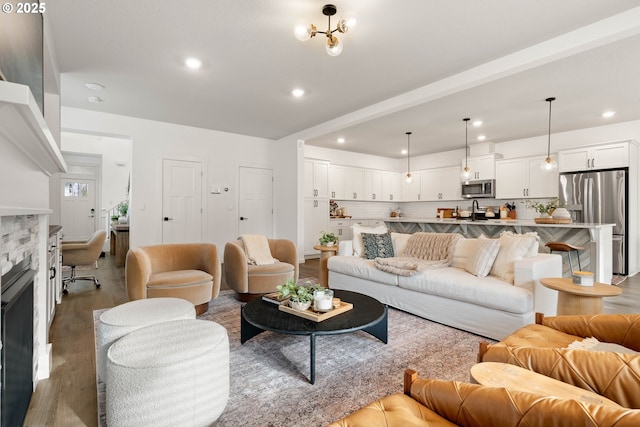 living area featuring a fireplace, recessed lighting, and wood finished floors