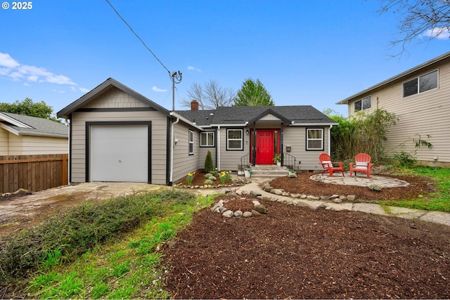 ranch-style house featuring a shingled roof, fence, a chimney, driveway, and an attached garage