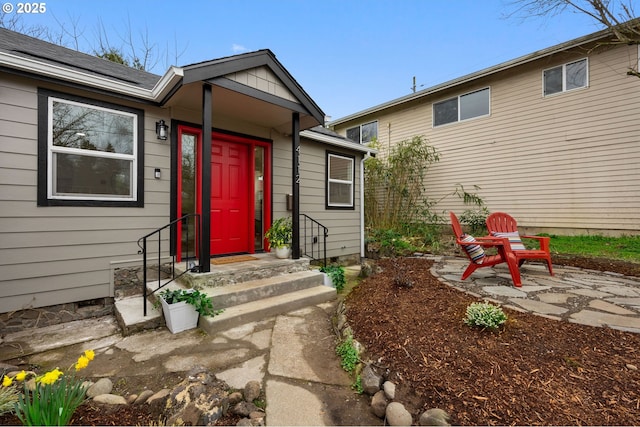 view of exterior entry featuring a patio area and roof mounted solar panels