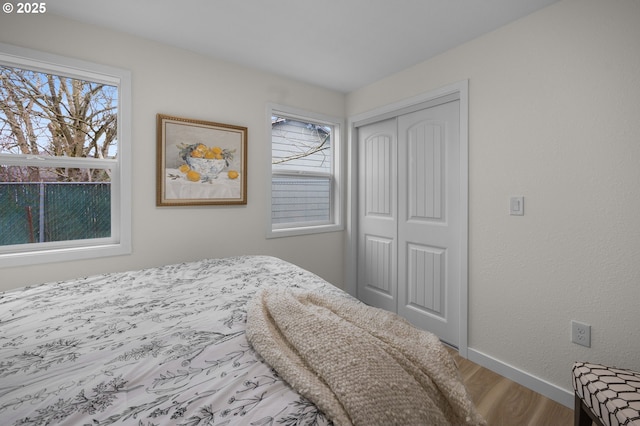 4112 NE 80th Ave, Portland, OR 97218 - bedroom with a closet, wood finished floors, multiple windows, and baseboards
