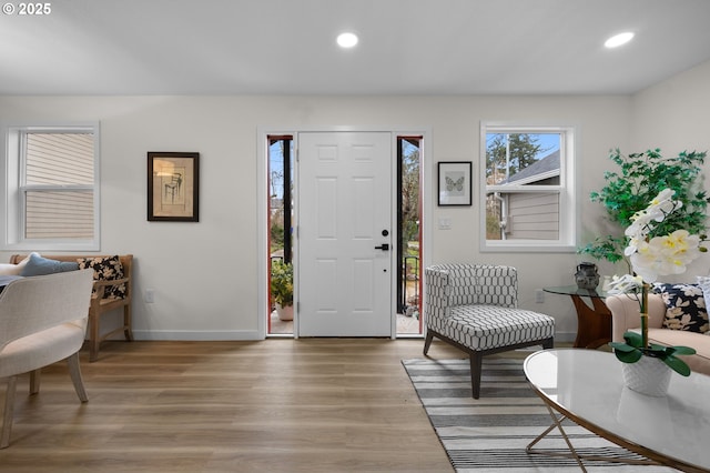 foyer with recessed lighting, baseboards, and light wood-style flooring