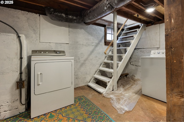 below grade area with stairs and washer and clothes dryer