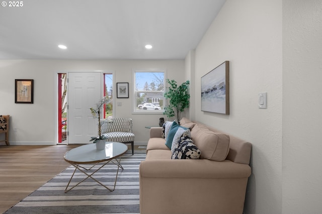 living area featuring recessed lighting, wood finished floors, and baseboards