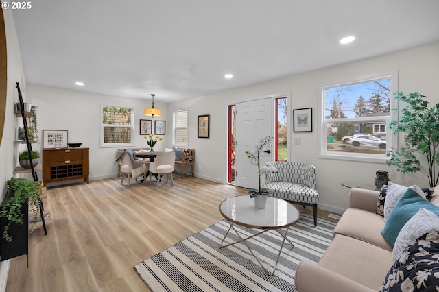 living room featuring recessed lighting, light wood-type flooring, and baseboards