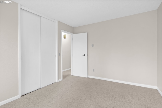 unfurnished bedroom featuring carpet and a closet