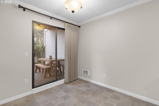 unfurnished room with ornamental molding and a textured ceiling