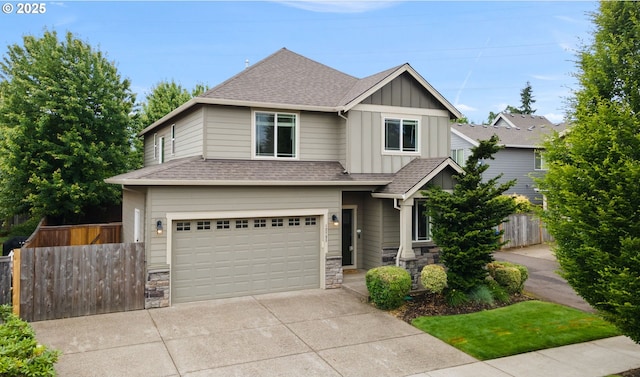 12795 Lindsay Anne Ln, Oregon City, OR 97045 - view of front of house featuring board and batten siding, an attached garage, a shingled roof, concrete driveway, and stone siding