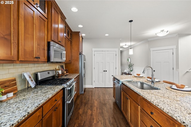 12795 Lindsay Anne Ln, Oregon City, OR 97045 - kitchen with stainless steel appliances, a sink, brown cabinetry, backsplash, and light stone counters