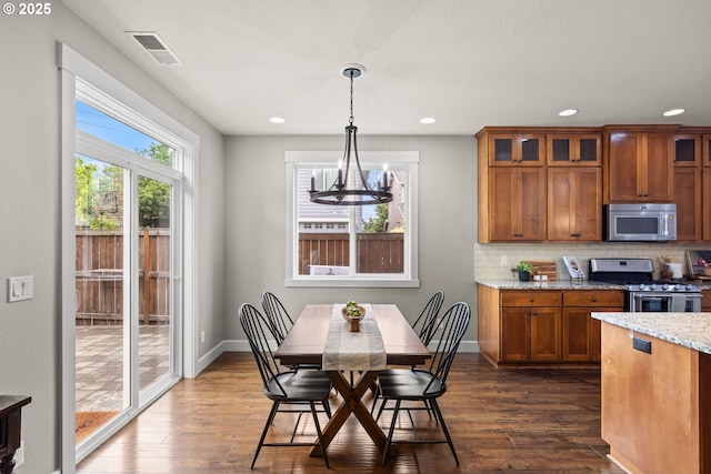 12795 Lindsay Anne Ln, Oregon City, OR 97045 - kitchen featuring appliances with stainless steel finishes, brown cabinets, dark wood-type flooring, and recessed lighting