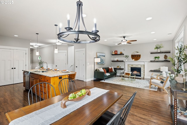12795 Lindsay Anne Ln, Oregon City, OR 97045 - dining room featuring ceiling fan, recessed lighting, a stone fireplace, a chandelier, and dark wood-style floors