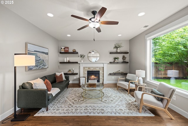 12795 Lindsay Anne Ln, Oregon City, OR 97045 - living room with wood finished floors, a stone fireplace, baseboards, ceiling fan, and recessed lighting
