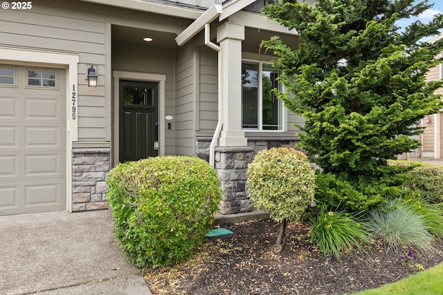 12795 Lindsay Anne Ln, Oregon City, OR 97045 - entrance to property featuring stone siding, an attached garage, and covered porch