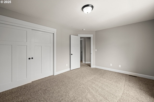 12795 Lindsay Anne Ln, Oregon City, OR 97045 - unfurnished bedroom featuring light colored carpet, baseboards, and a closet