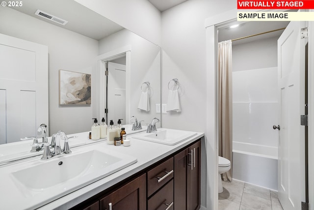 bathroom with double vanity, visible vents, a sink, and toilet
