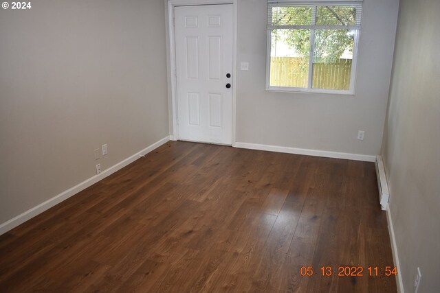 unfurnished room featuring dark hardwood / wood-style flooring