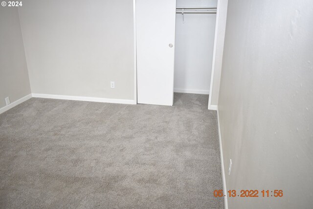 unfurnished bedroom with a closet and carpet