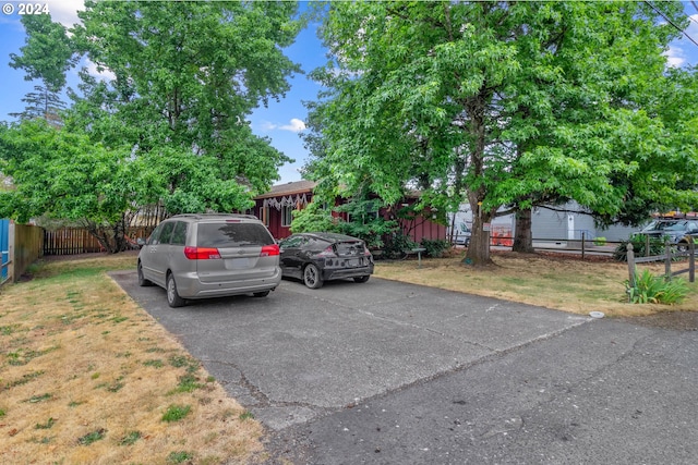 view of car parking with a yard