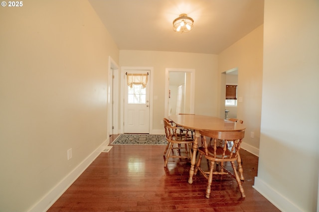 dining area featuring baseboards and wood finished floors