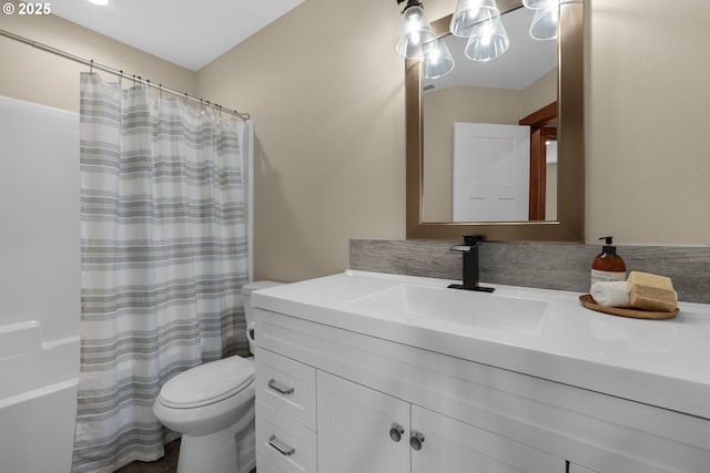 bathroom featuring vanity, curtained shower, and toilet