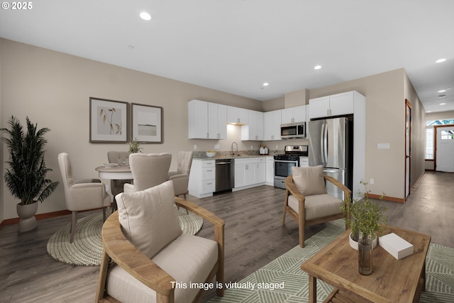 living room featuring recessed lighting, baseboards, and wood finished floors