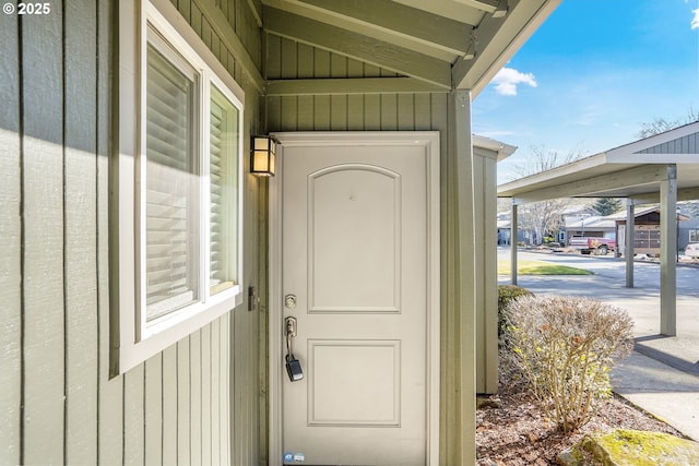 view of exterior entry with board and batten siding