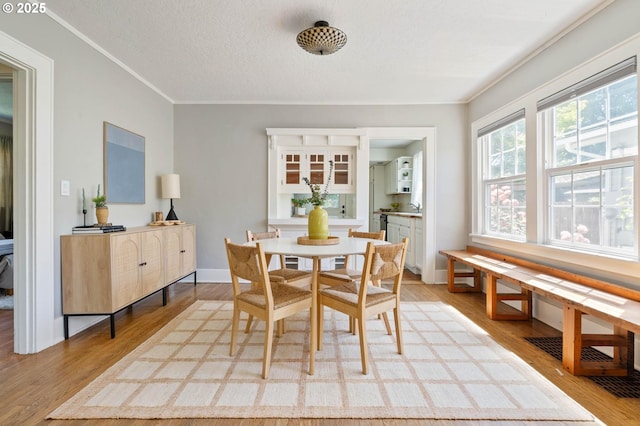 3620 NE 80th Ave, Portland, OR 97213 - dining room with light wood finished floors, a textured ceiling, ornamental molding, and baseboards