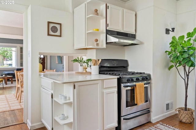 3620 NE 80th Ave, Portland, OR 97213 - kitchen featuring stainless steel range with gas stovetop, open shelves, under cabinet range hood, and light wood finished floors