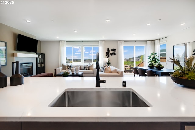 5591 N 87th Ave, Camas, WA 98607 - kitchen featuring open floor plan, light countertops, a glass covered fireplace, and recessed lighting