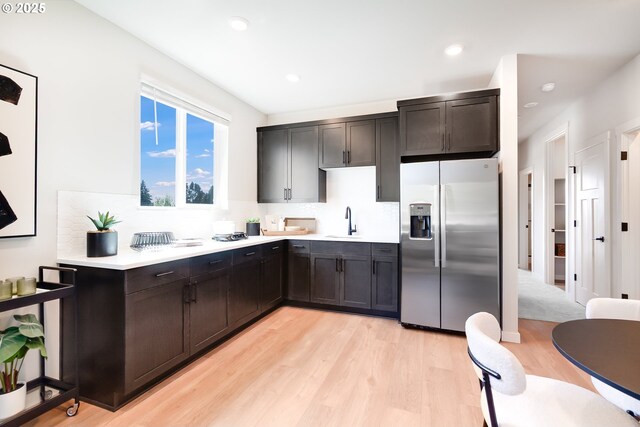 5591 N 87th Ave, Camas, WA 98607 - kitchen with stainless steel fridge, light countertops, backsplash, light wood finished floors, and recessed lighting