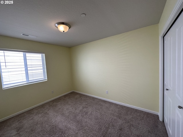 unfurnished bedroom featuring carpet, a closet, baseboards, and a textured ceiling